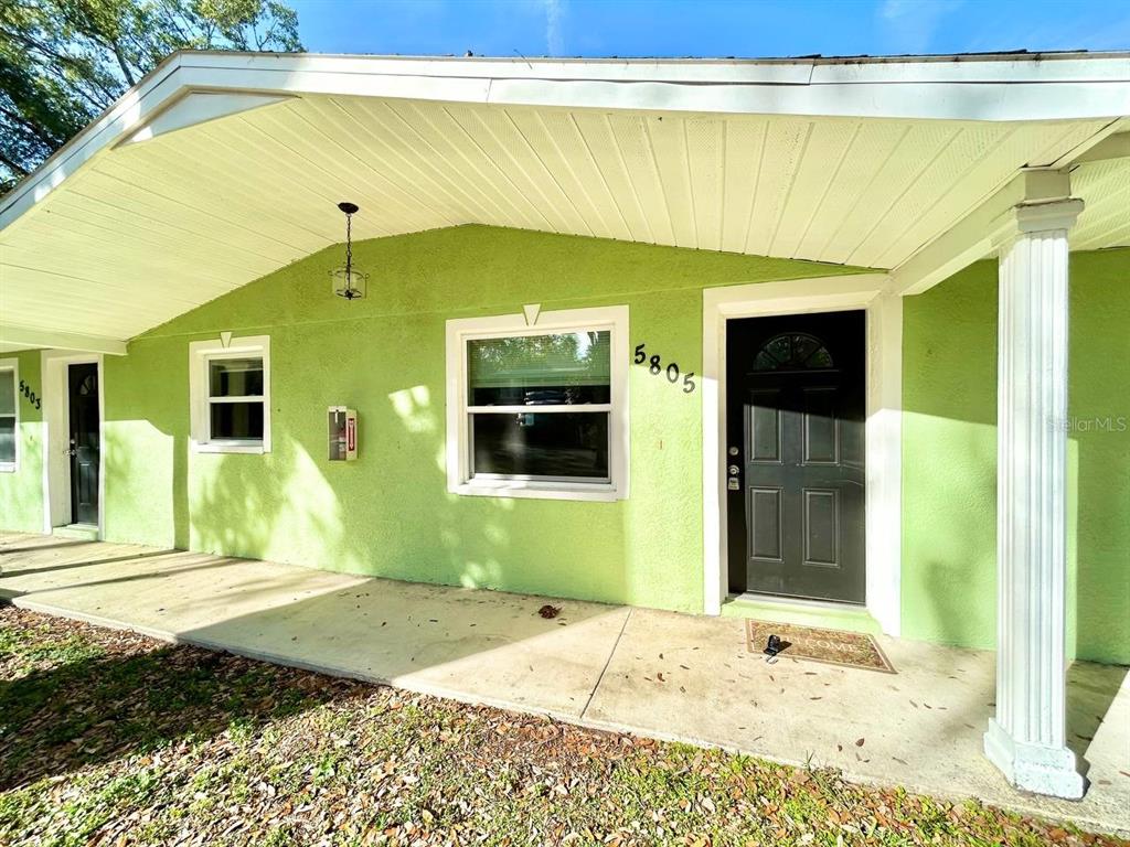 5805 Delaware Avenue New Port Richey, FL 34652 - Photo 2 of 12 a front view of a house with a yard