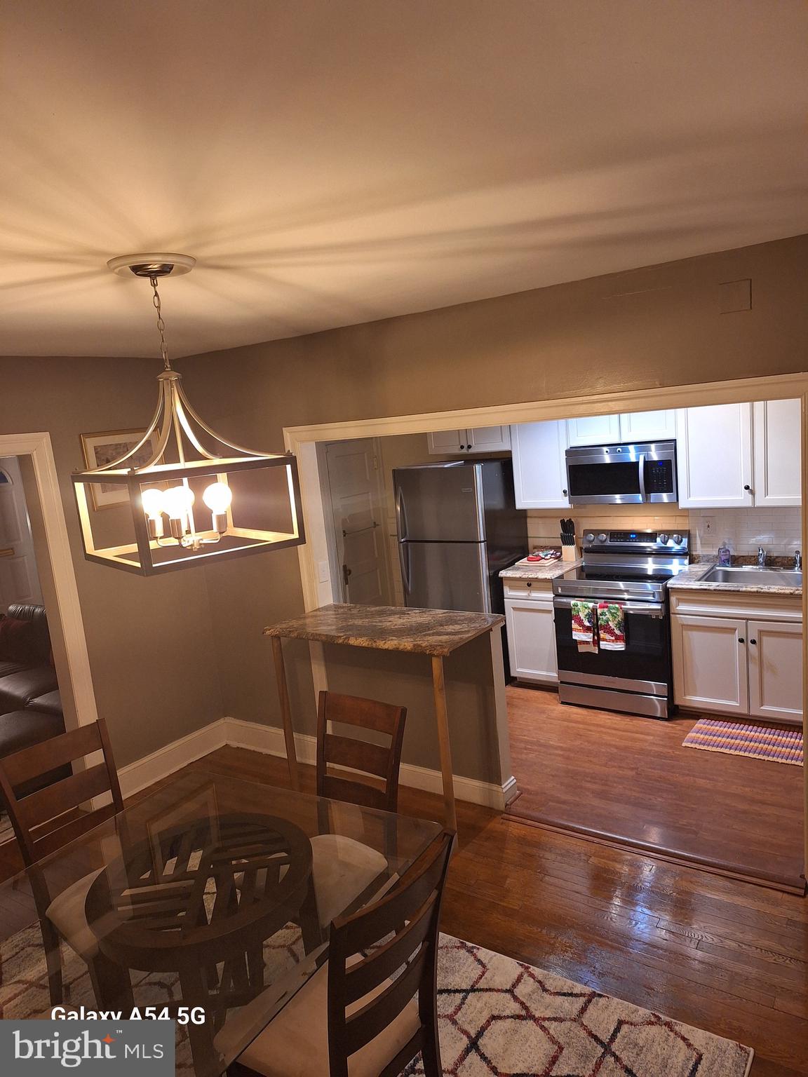3815 W Street Northwest Washington, DC 20007 - Photo 4 of 13 a kitchen with granite countertop a stove and a refrigerator