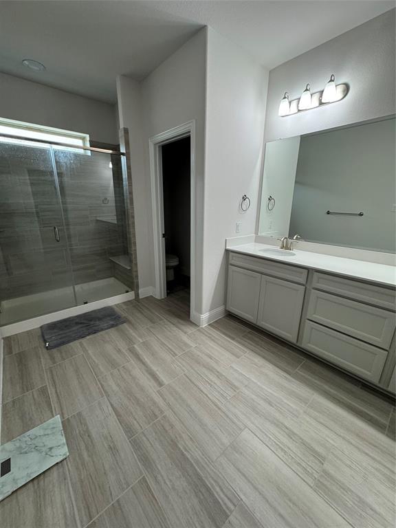 7849 Sunset Boulevard Rowlett, TX 75088 - Photo 11 of 19 This bathroom features a spacious walk-in shower with a glass enclosure and a built-in bench
