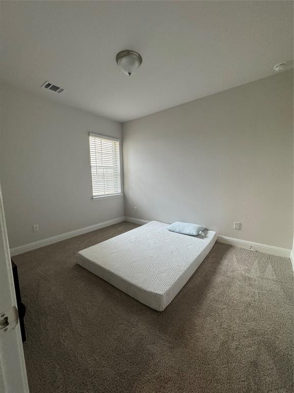 7849 Sunset Boulevard Rowlett, TX 75088 - Photo 13 of 19 This room features carpeted flooring, light-colored walls, and a window with blinds