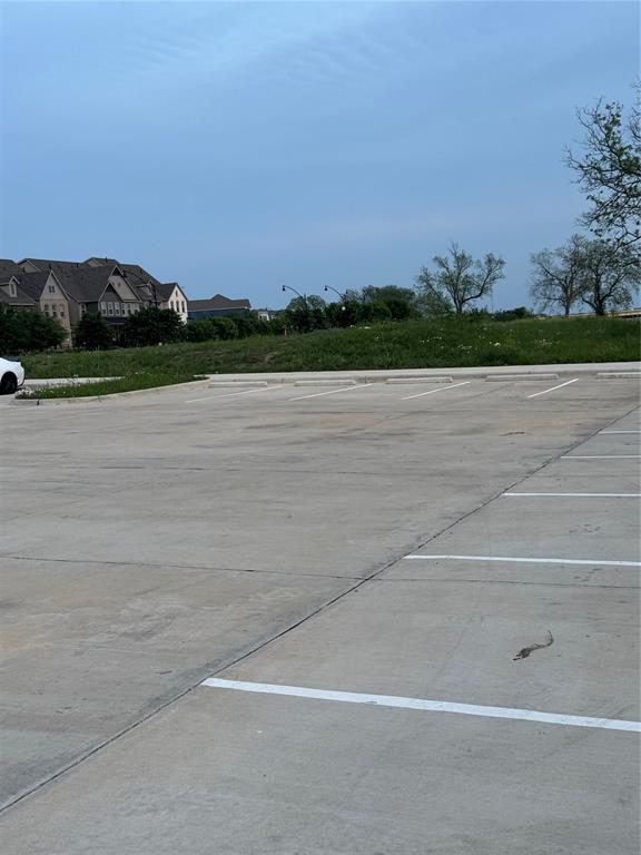 7849 Sunset Boulevard Rowlett, TX 75088 - Photo 15 of 19 The property is situated in a community with several residences visible in the background, featuring various architectural styles and rooflines