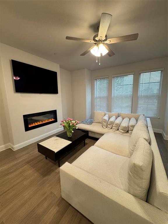 7849 Sunset Boulevard Rowlett, TX 75088 - Photo 4 of 19 This inviting living space features hardwood flooring and a ceiling fan with integrated lighting