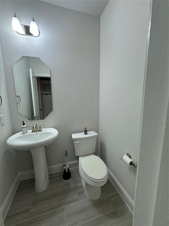7849 Sunset Boulevard Rowlett, TX 75088 - Photo 8 of 19 Powder room featuring a pedestal sink, an octagonal mirror, and tile flooring