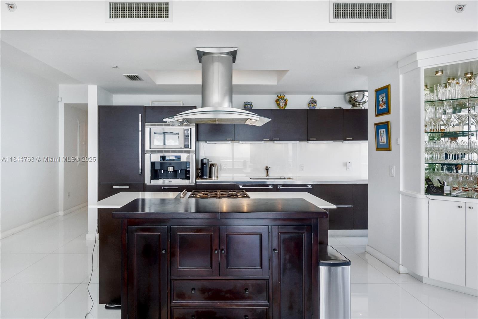 3737 Collins Avenue, Unit S801 Miami Beach, FL 33140 - Photo 11 of 24 a kitchen with a stove and a refrigerator