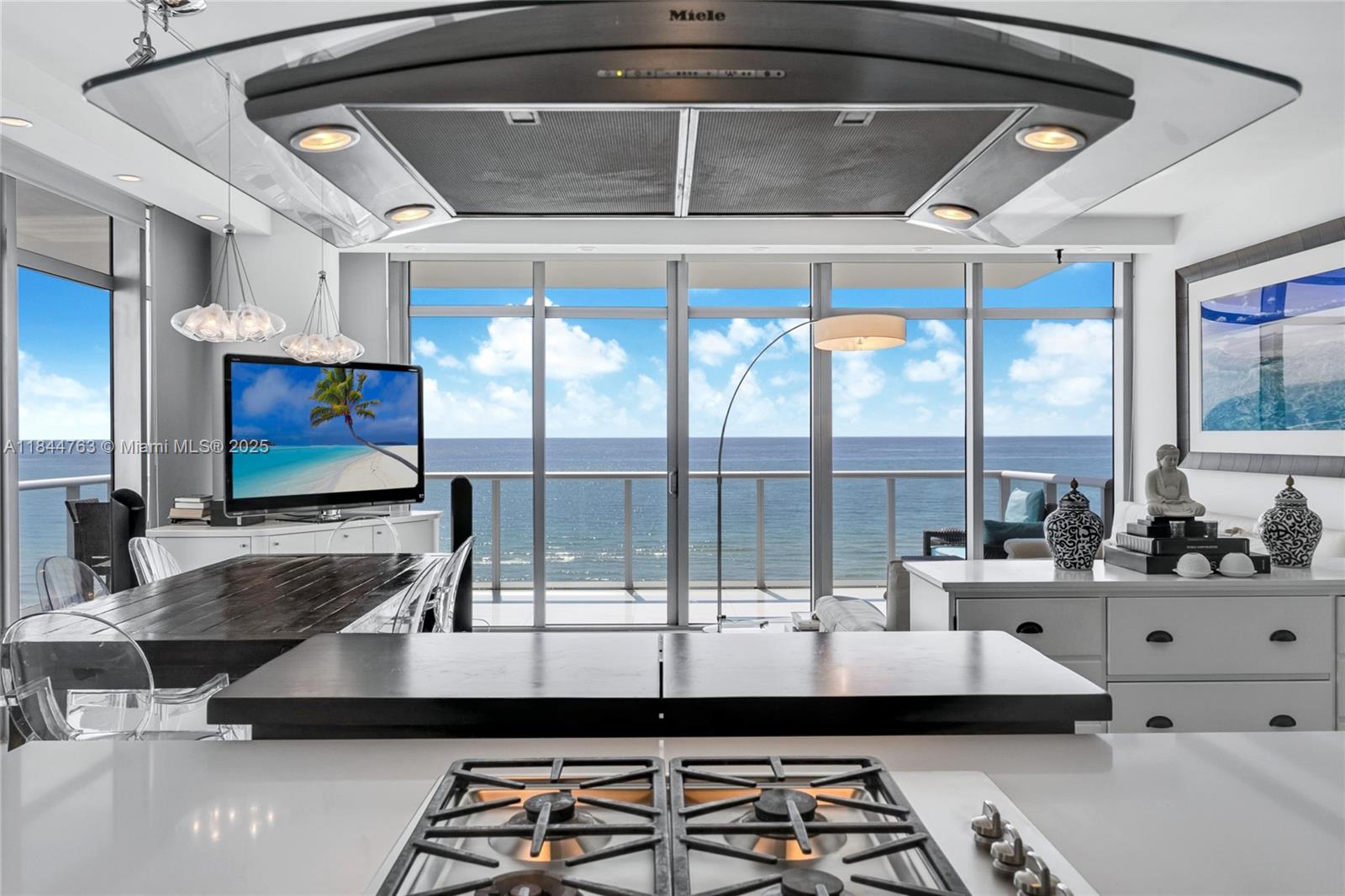 3737 Collins Avenue, Unit S801 Miami Beach, FL 33140 - Photo 12 of 24 a room with furniture and flat screen tv