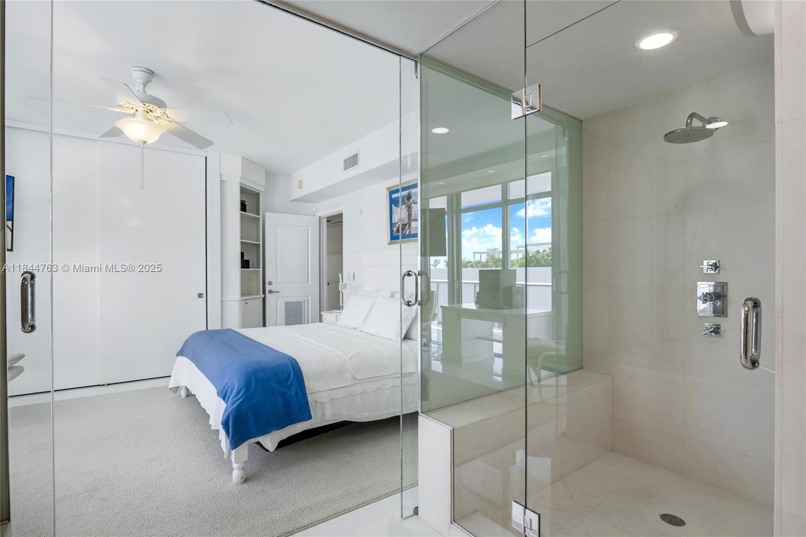 3737 Collins Avenue, Unit S801 Miami Beach, FL 33140 - Photo 16 of 24 a bedroom with a bed and a chandelier