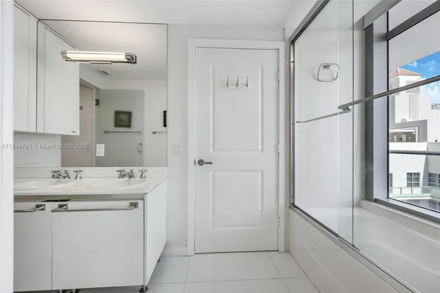 a utility room with cabinets washer and dryer