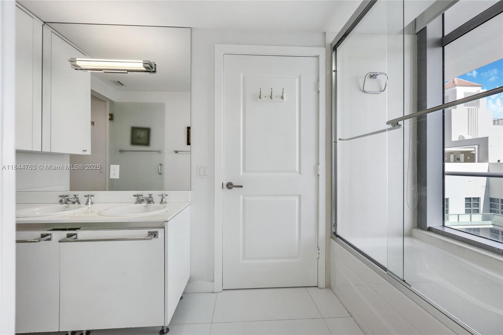3737 Collins Avenue, Unit S801 Miami Beach, FL 33140 - Photo 21 of 24 a utility room with cabinets washer and dryer