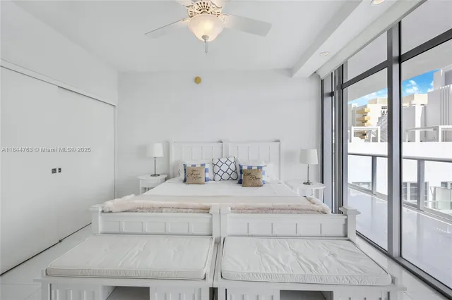 a bedroom with a large bed and a chandelier