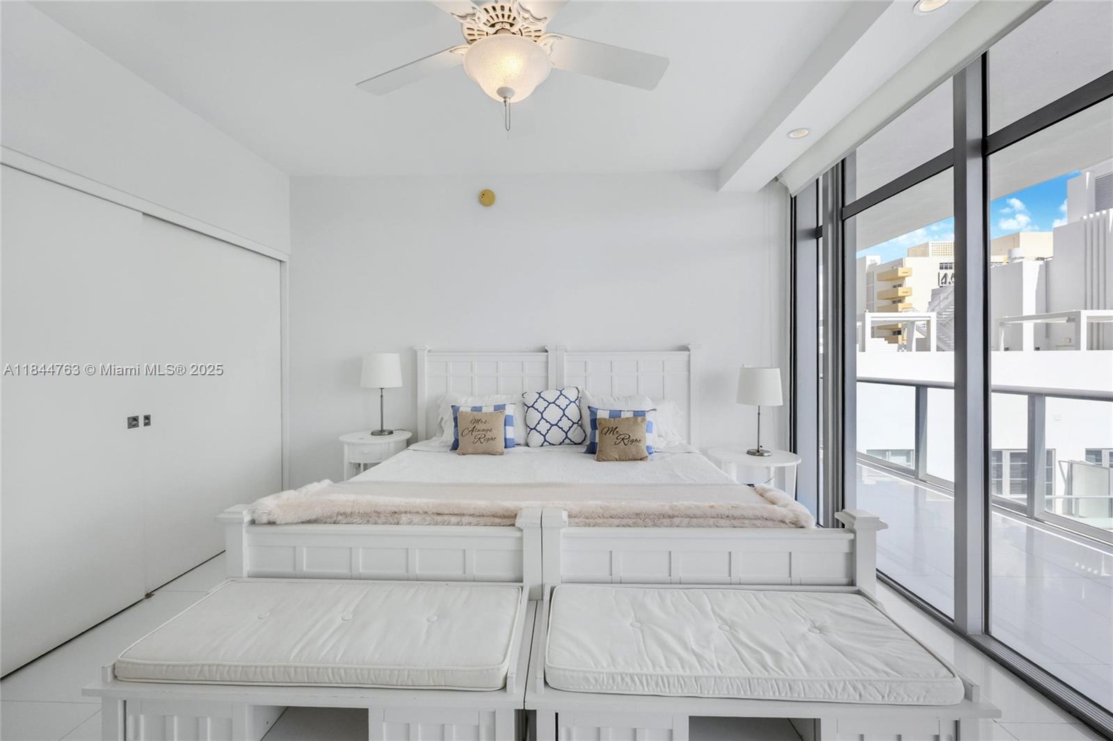 3737 Collins Avenue, Unit S801 Miami Beach, FL 33140 - Photo 22 of 24 a bedroom with a large bed and a chandelier