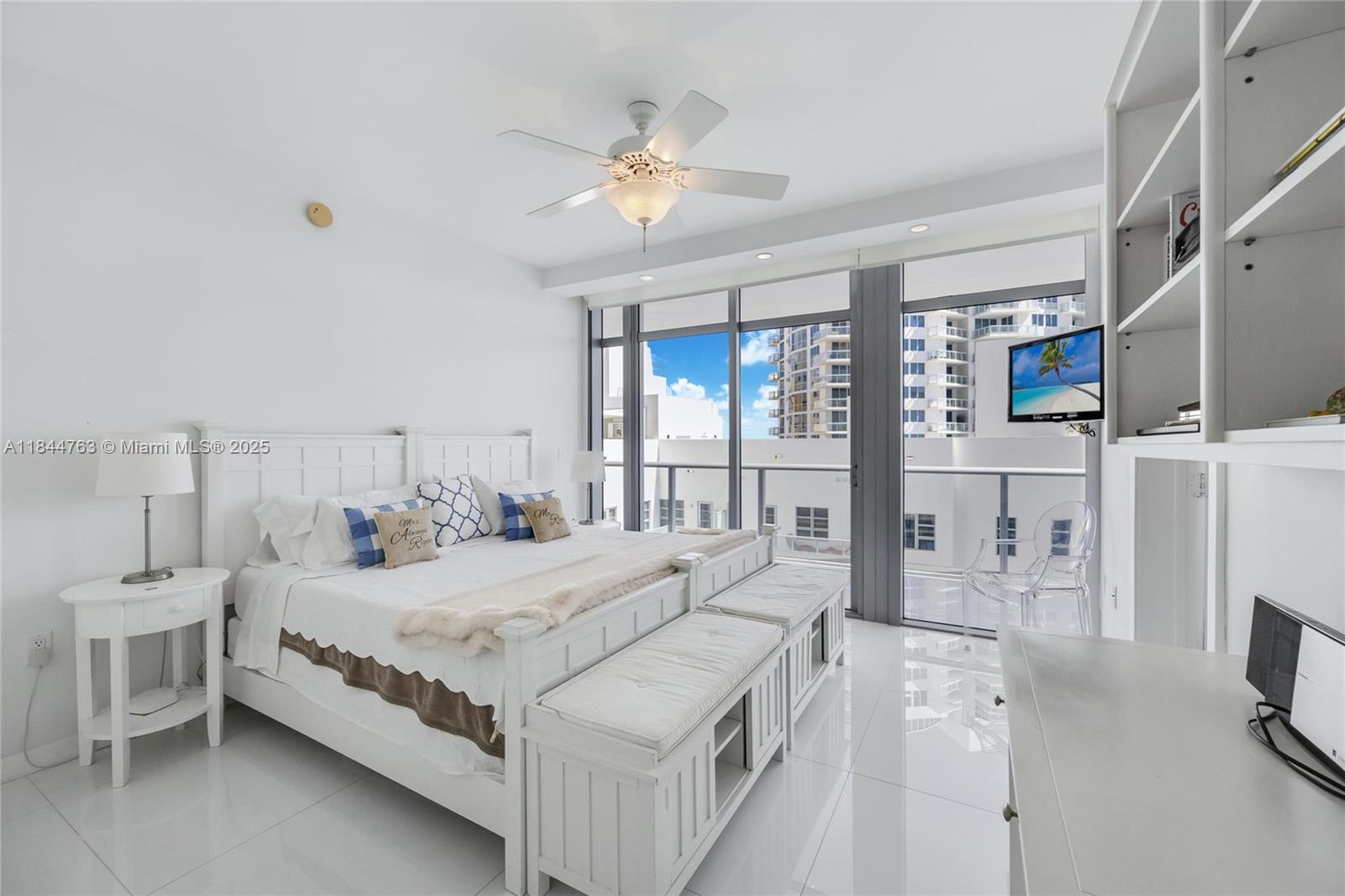 3737 Collins Avenue, Unit S801 Miami Beach, FL 33140 - Photo 23 of 24 a bedroom with a large bed and a chandelier