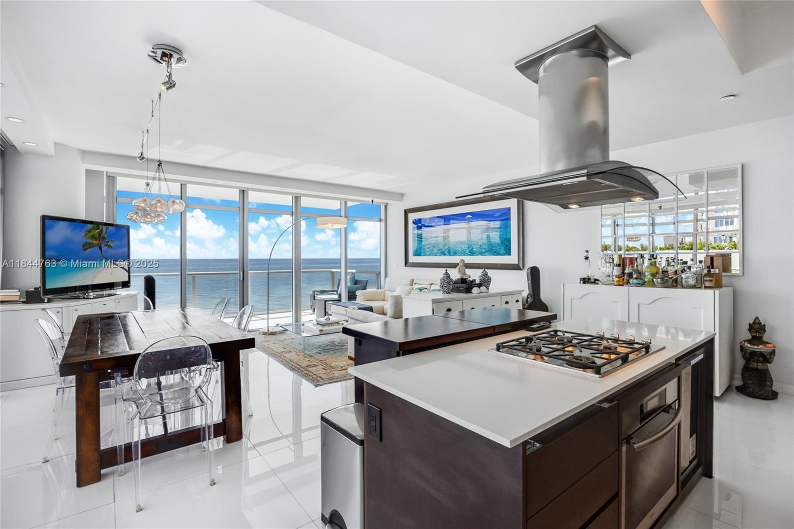 3737 Collins Avenue, Unit S801 Miami Beach, FL 33140 - Photo 9 of 24 a kitchen with a stove a sink and a table