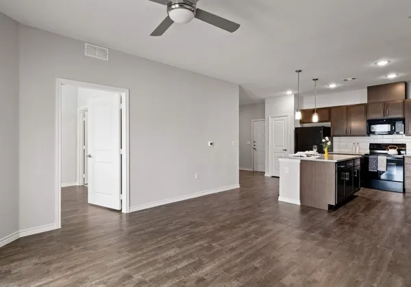 a view of kitchen with microwave and refrigerator