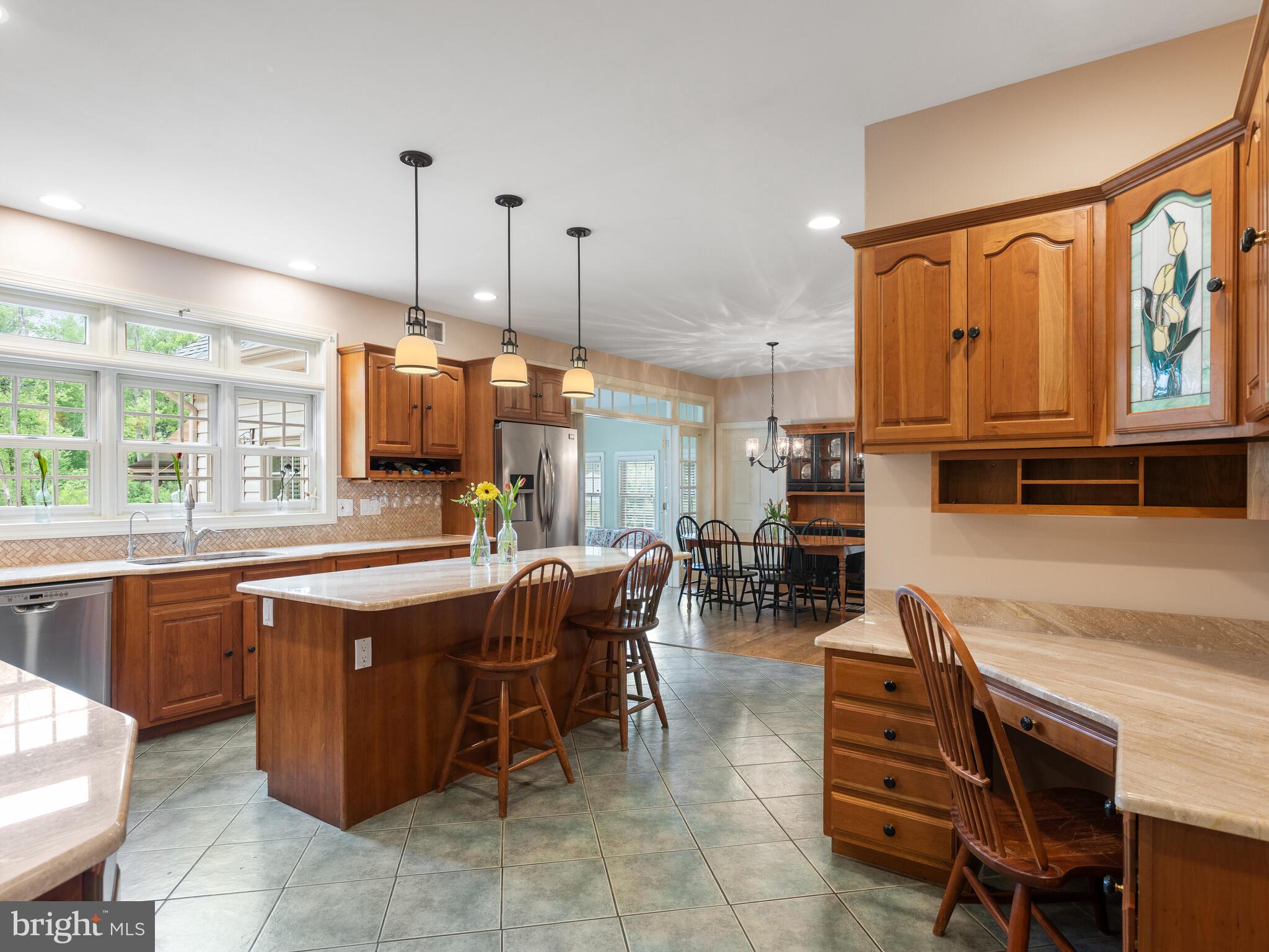 648 East Reeceville Road Coatesville, PA 19320 - Photo 18 of 49 a dining hall with stainless steel appliances granite countertop a kitchen island a table and chairs in it