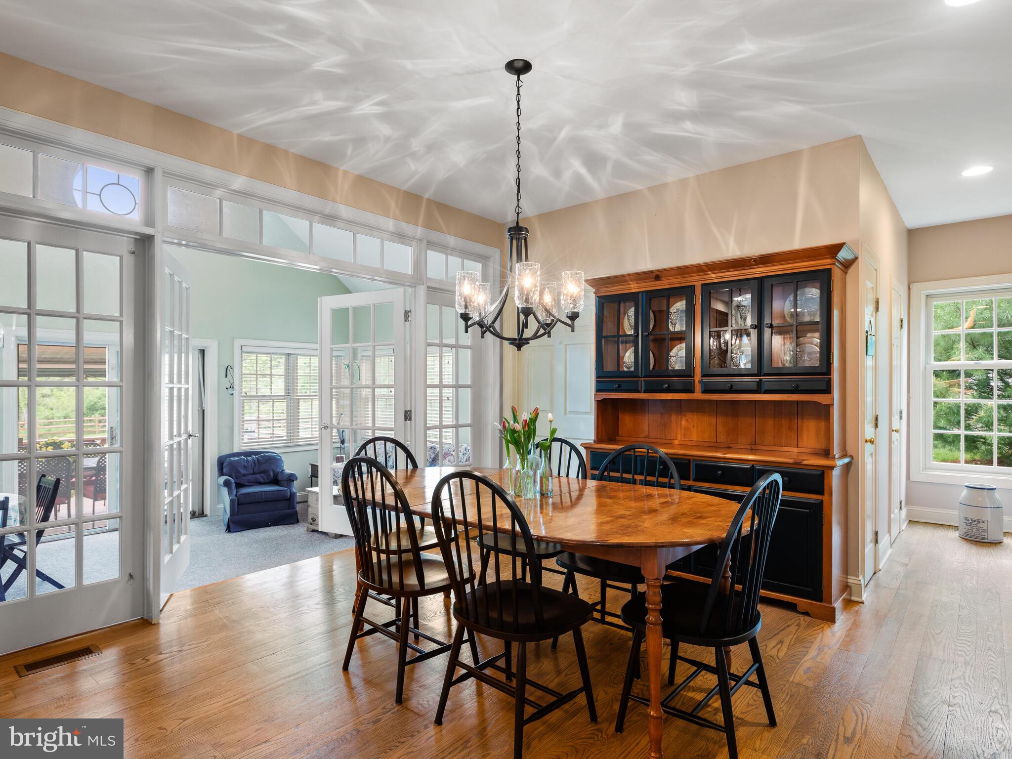 648 East Reeceville Road Coatesville, PA 19320 - Photo 21 of 49 a dining room with furniture a chandelier and wooden floor