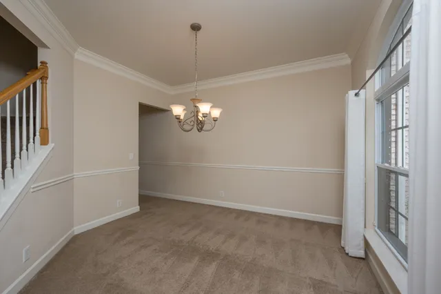 a view of an empty room with a fireplace and a window