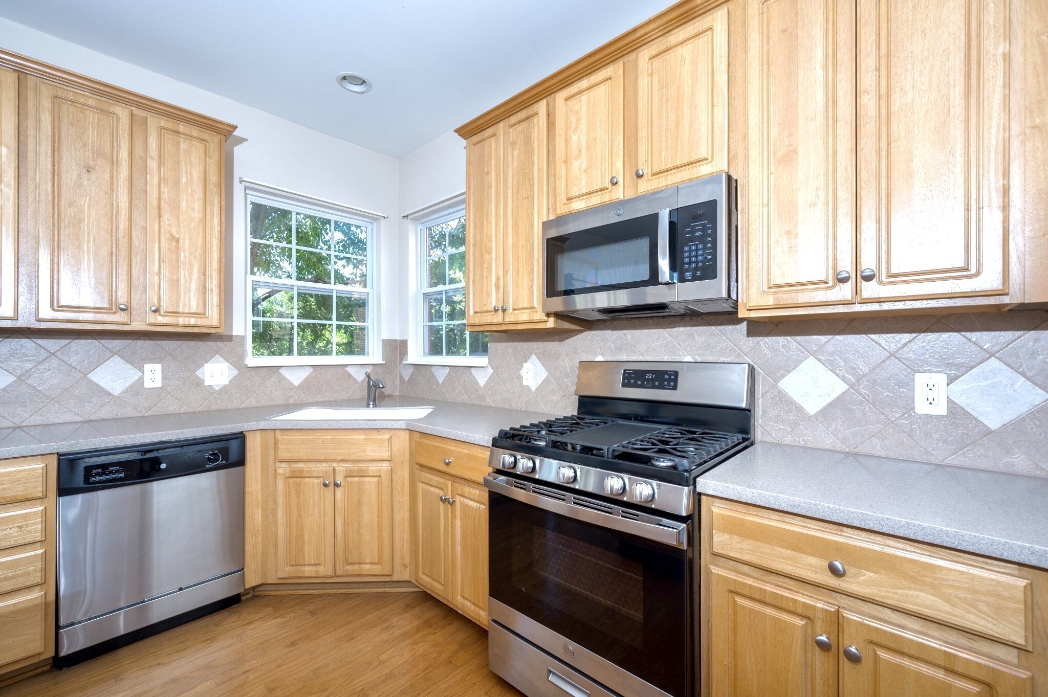1322 Tilton Drive Franklin, TN 37067 - Photo 17 of 60 a kitchen with granite countertop a stove a sink and a microwave