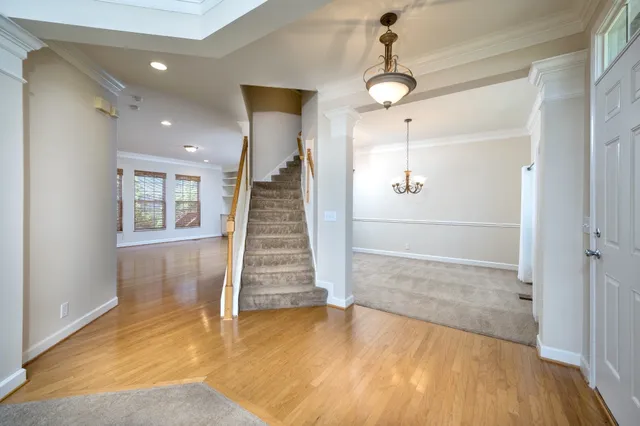 an empty room with a window and a ceiling fan