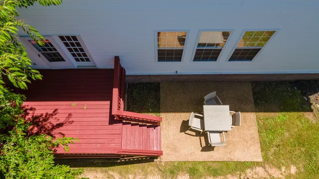 a view of a backyard with wooden fence and a bench