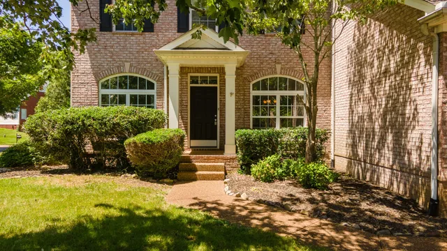 a front view of a house with a yard