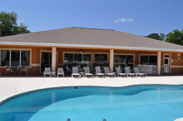 a view of a house with backyard sitting area and garden