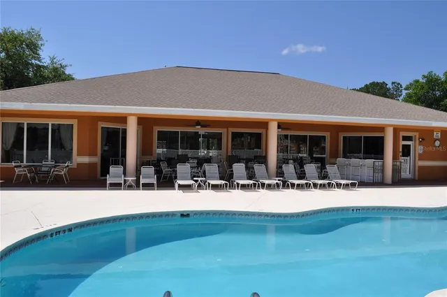 a view of a house with backyard sitting area and garden