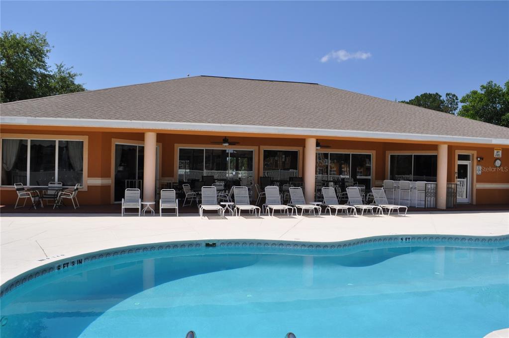 4600 East Moody Boulevard, Unit 3J Bunnell, FL 32110 - Photo 16 of 20 a front view of house with yard outdoor seating and large tree