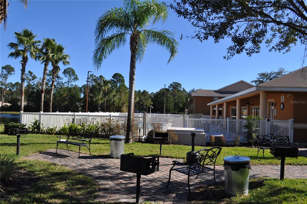 4600 East Moody Boulevard, Unit 3J Bunnell, FL 32110 - Photo 17 of 20 a view of a house with backyard sitting area and garden