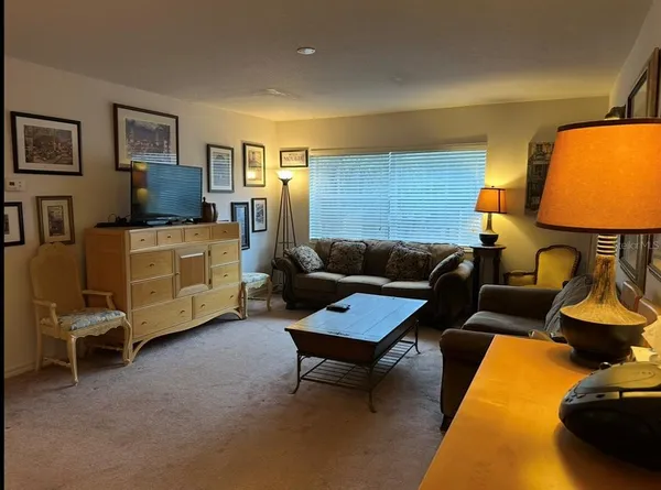 a living room with furniture and a lamp