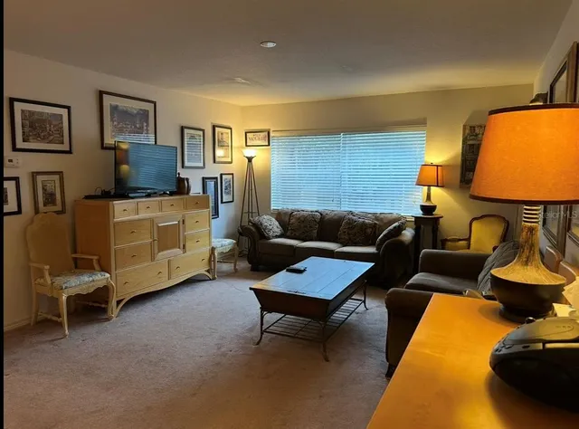 a living room with furniture and a lamp