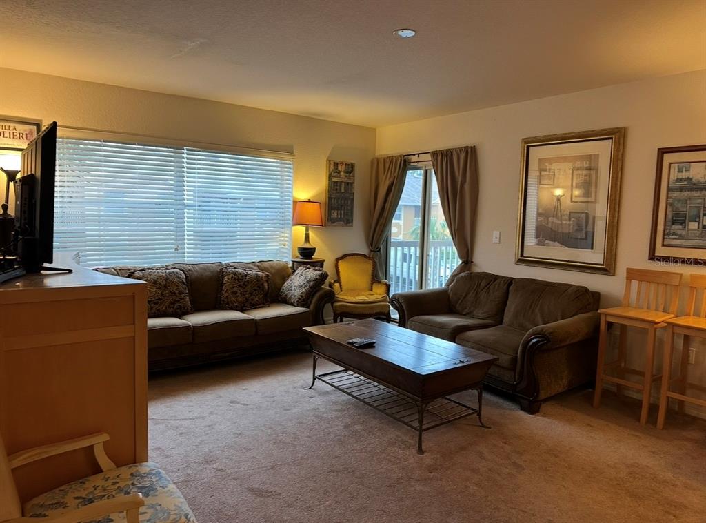 4600 East Moody Boulevard, Unit 3J Bunnell, FL 32110 - Photo 6 of 20 a living room with furniture and a flat screen tv