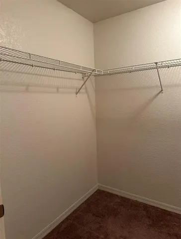 a bedroom with a bed a mirror on dresser and a large mirror