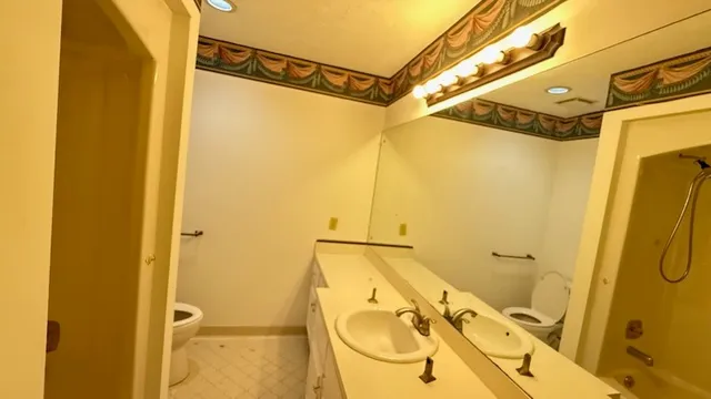 a bathroom with a sink a granite and shower