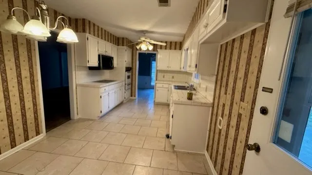 a bathroom with a sink a mirror and shower