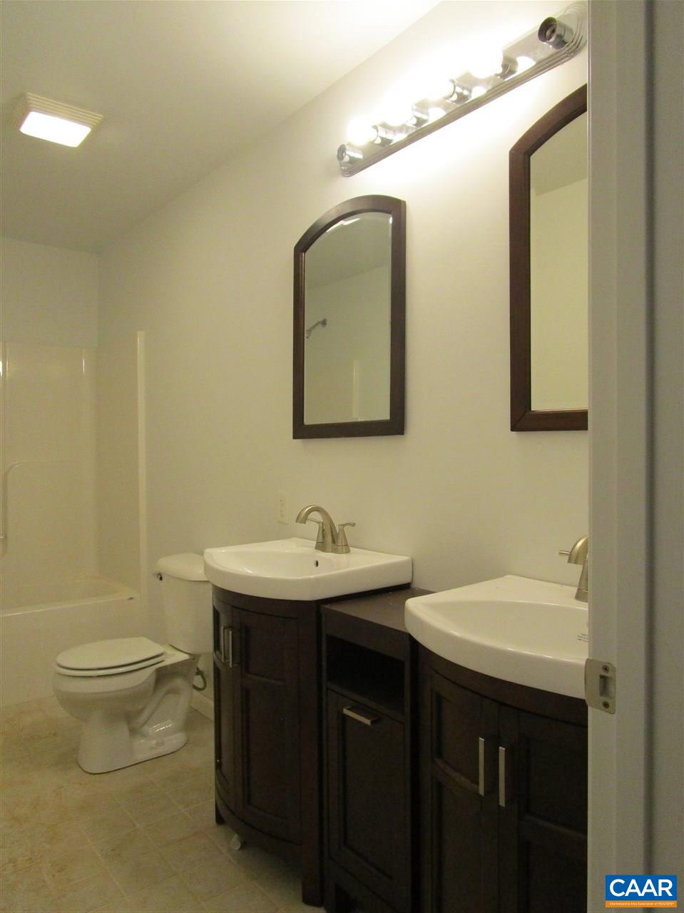 6814 Courthouse Road Louisa, VA 23093 - Photo 19 of 32 a bathroom with a toilet sink and mirror