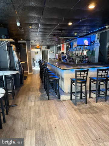 a outdoor space with lots of wooden furniture and stainless steel appliances