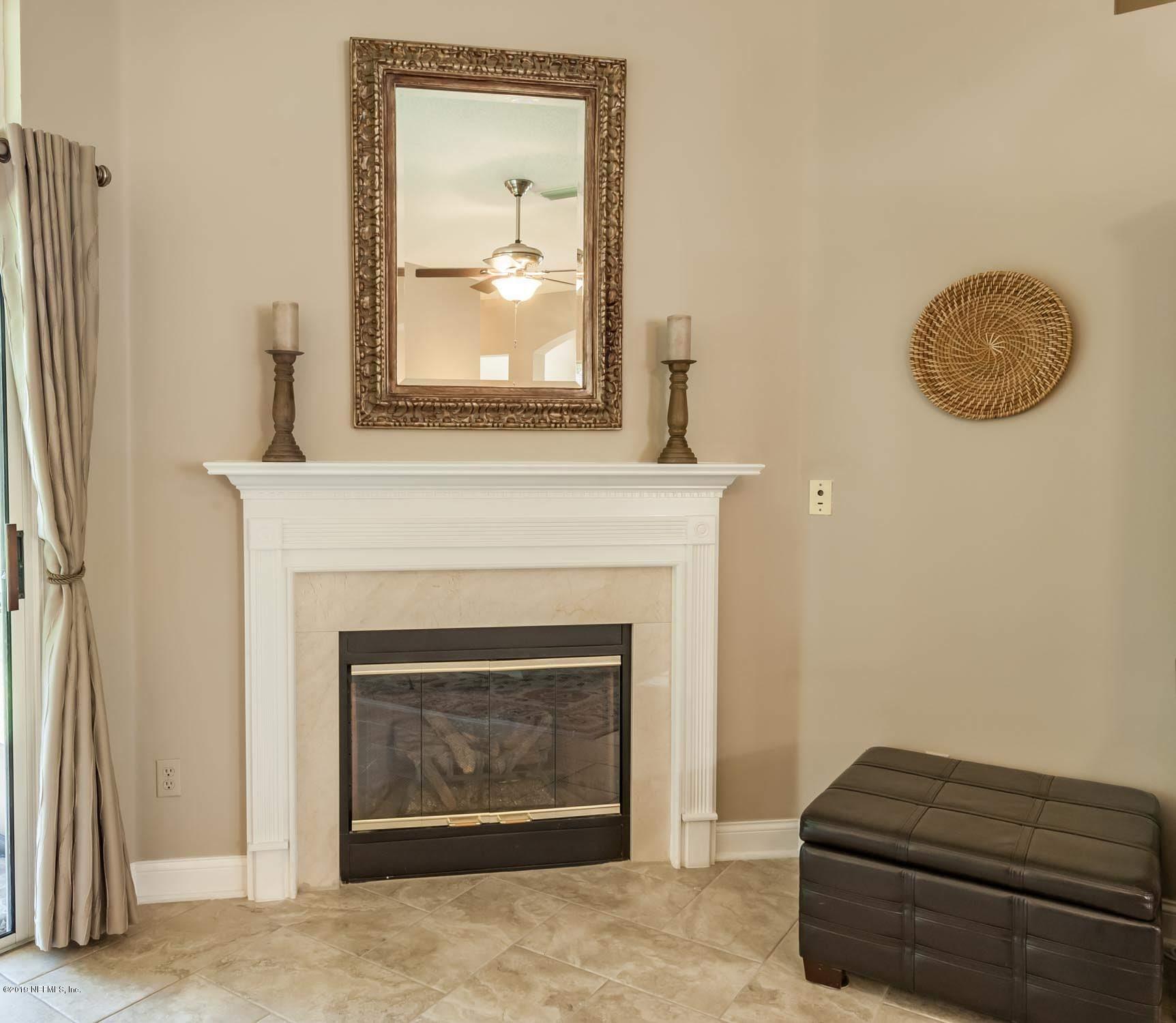 1152 Sandlake Road St. Augustine, FL 32092 - Photo 12 of 46 a living room with a fireplace and a wooden floor