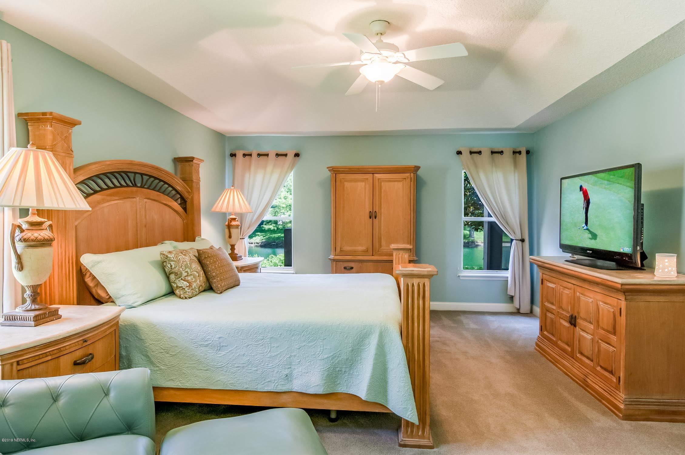 1152 Sandlake Road St. Augustine, FL 32092 - Photo 14 of 46 a bedroom with a bed a flat screen tv and dresser