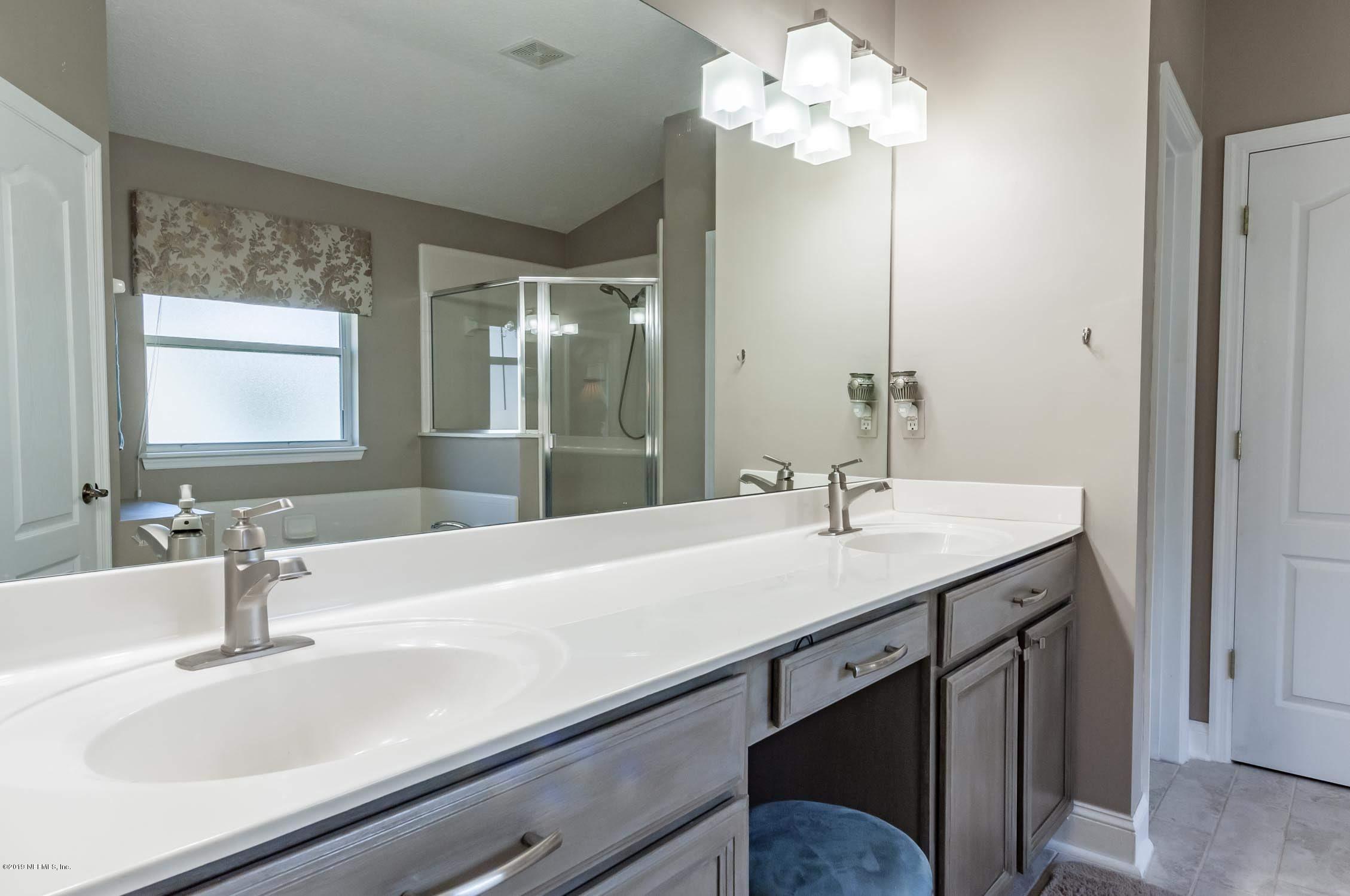 1152 Sandlake Road St. Augustine, FL 32092 - Photo 18 of 46 a bathroom with a sink a vanity and a mirror
