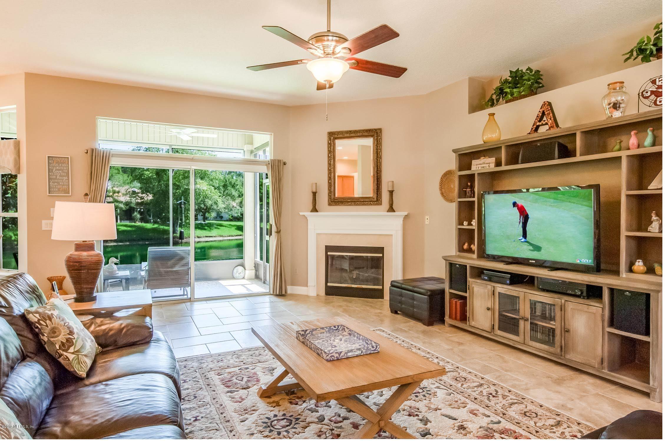1152 Sandlake Road St. Augustine, FL 32092 - Photo 2 of 46 a living room with furniture a flat screen tv and a fireplace