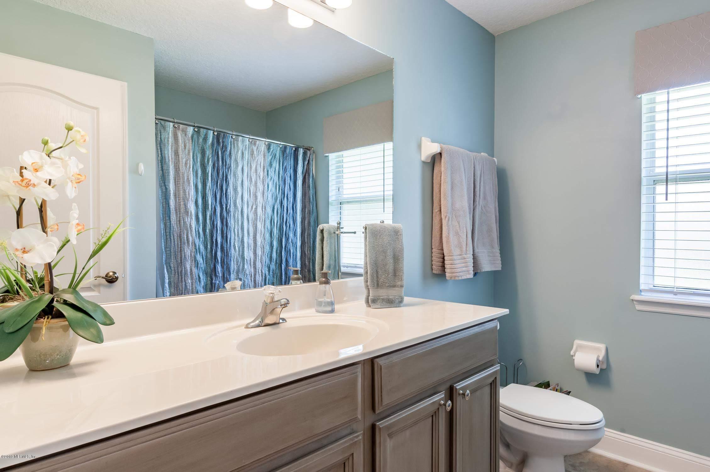 1152 Sandlake Road St. Augustine, FL 32092 - Photo 22 of 46 a bathroom with a sink a toilet and a large mirror