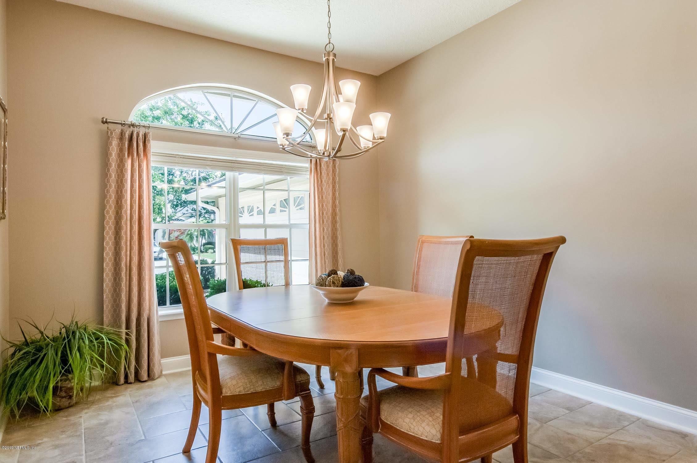 1152 Sandlake Road St. Augustine, FL 32092 - Photo 3 of 46 a view of a dining room with furniture a chandelier and wooden floor