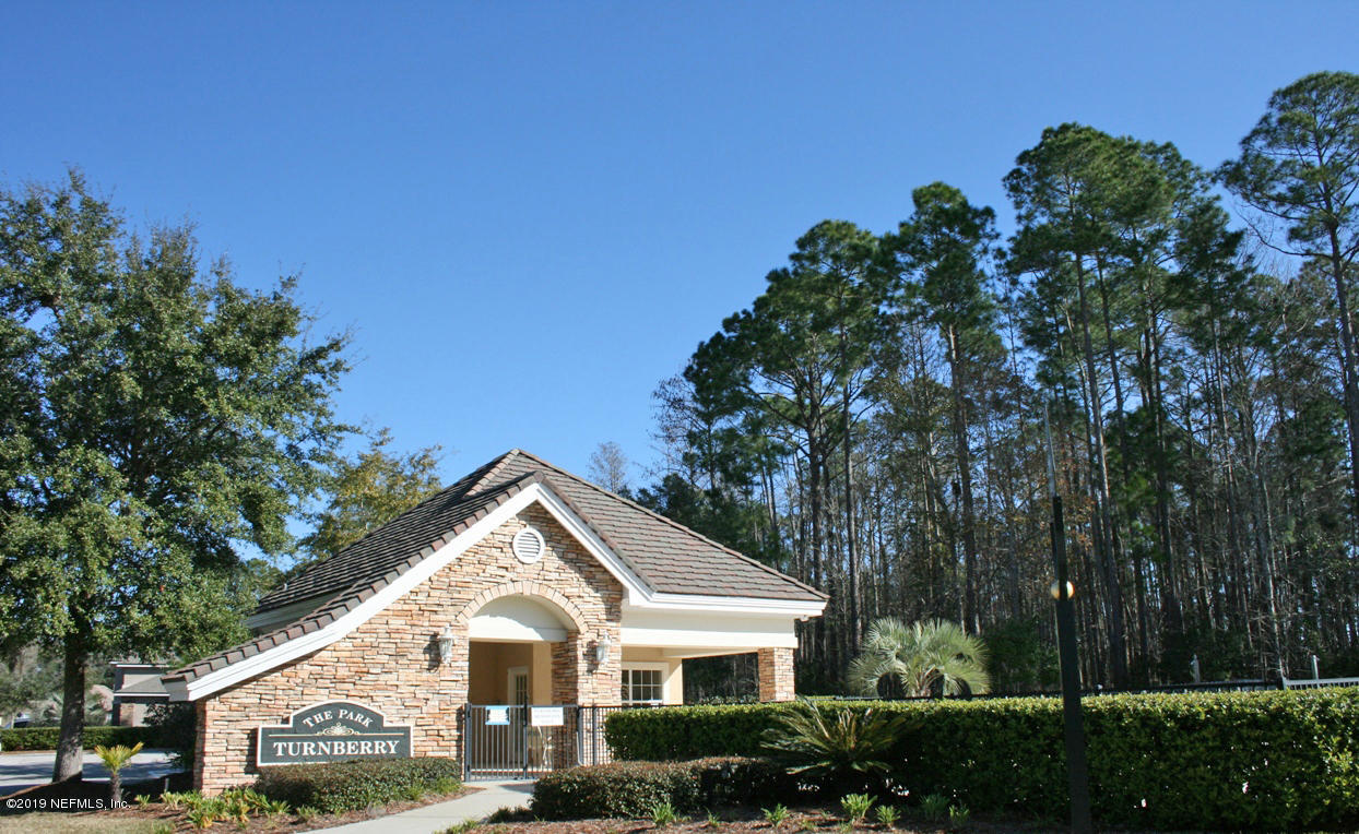 1152 Sandlake Road St. Augustine, FL 32092 - Photo 31 of 46 a front view of a house with a yard and garage