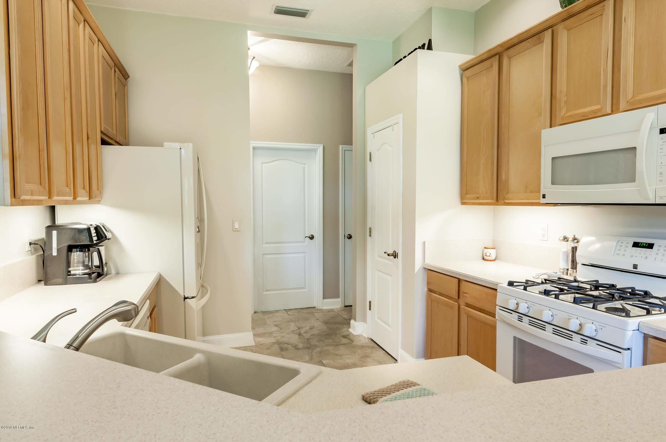 1152 Sandlake Road St. Augustine, FL 32092 - Photo 6 of 46 a kitchen with stainless steel appliances granite countertop a sink stove and refrigerator