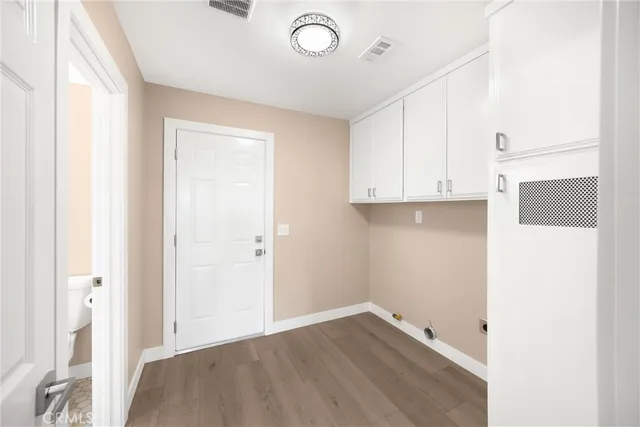 a view of a hallway to a livingroom with furniture