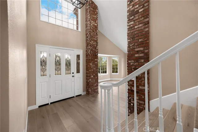 a view of entryway with wooden floor and stairs