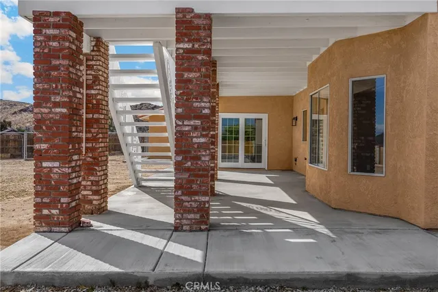 a view of a house with a yard and sitting area