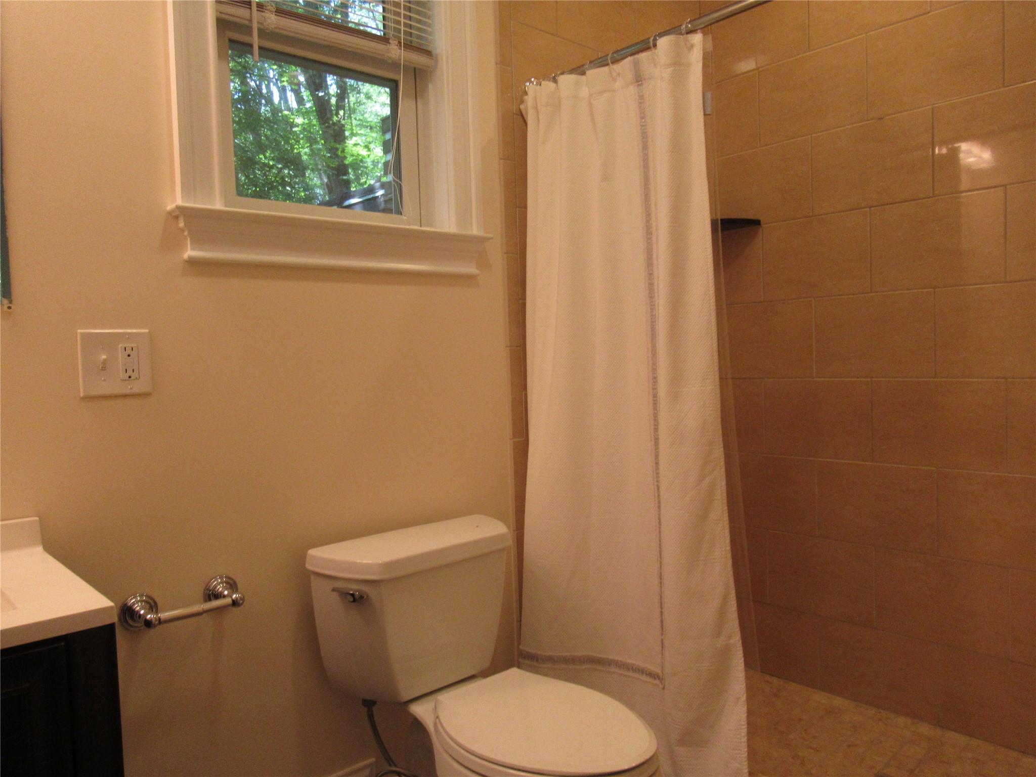 101 Bundy Hill Road Holmes, NY 12531 - Photo 11 of 28 a white toilet sitting next to a shower curtain