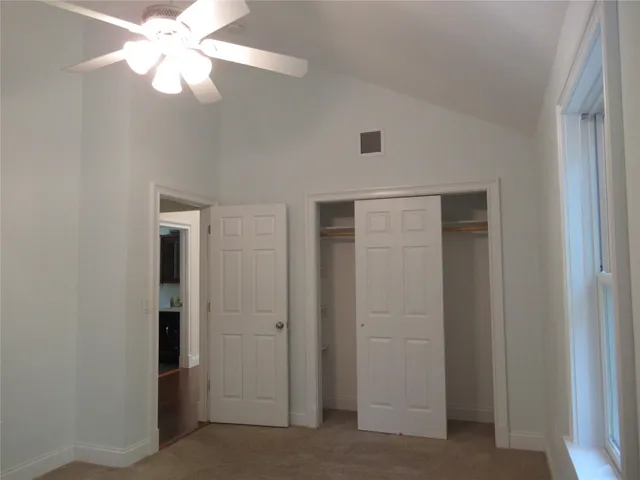 a view of backyard with wooden fence and a bench