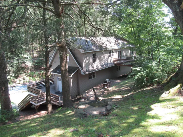 a view of a wooden bench sitting in middle of a yard